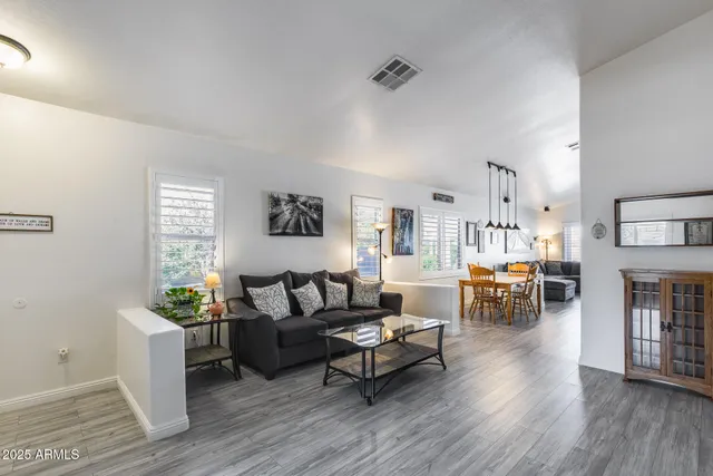 a living room with furniture and wooden floor