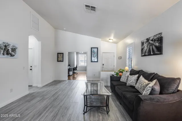 a living room with furniture and wooden floor
