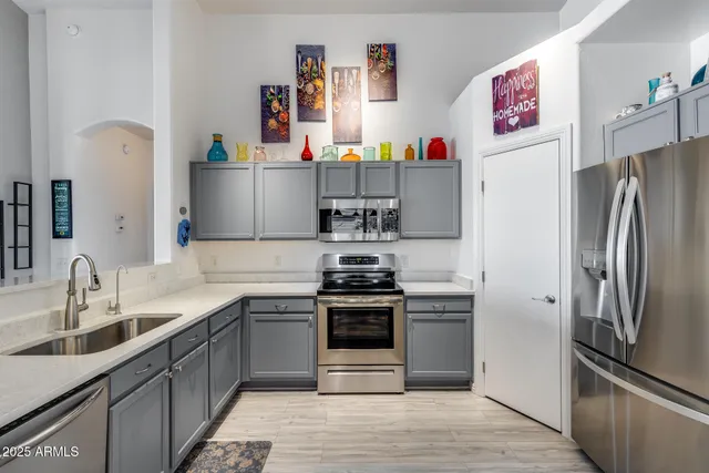 a kitchen with kitchen island a sink stove and refrigerator