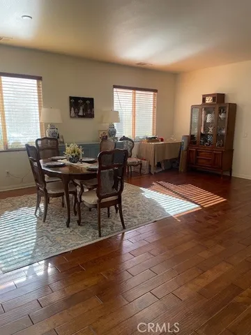 a kitchen with granite countertop a refrigerator a stove a sink a microwave and cabinets