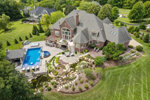 an aerial view of a house with yard swimming pool and outdoor seating