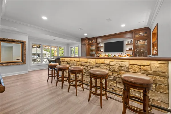 a dining room with furniture a floor to ceiling window and a chandelier
