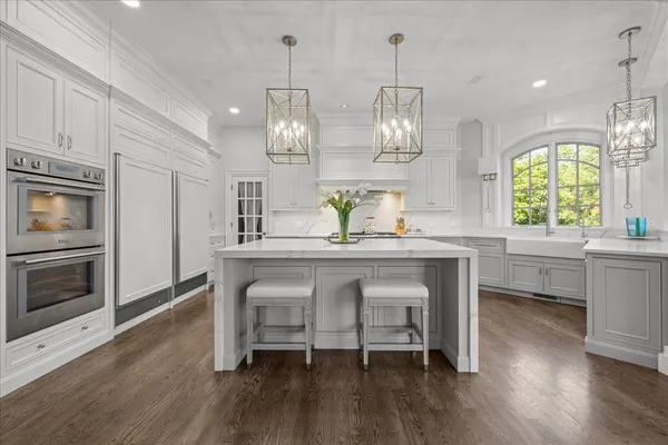 a living room with furniture and floor to ceiling windows