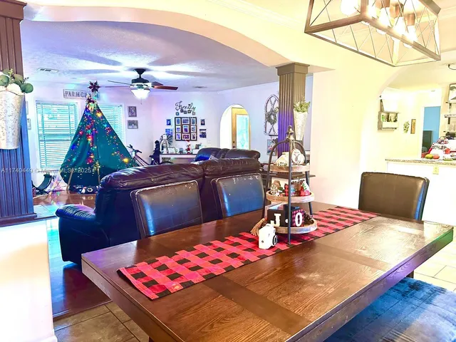 a bed room with a bed television and a large window