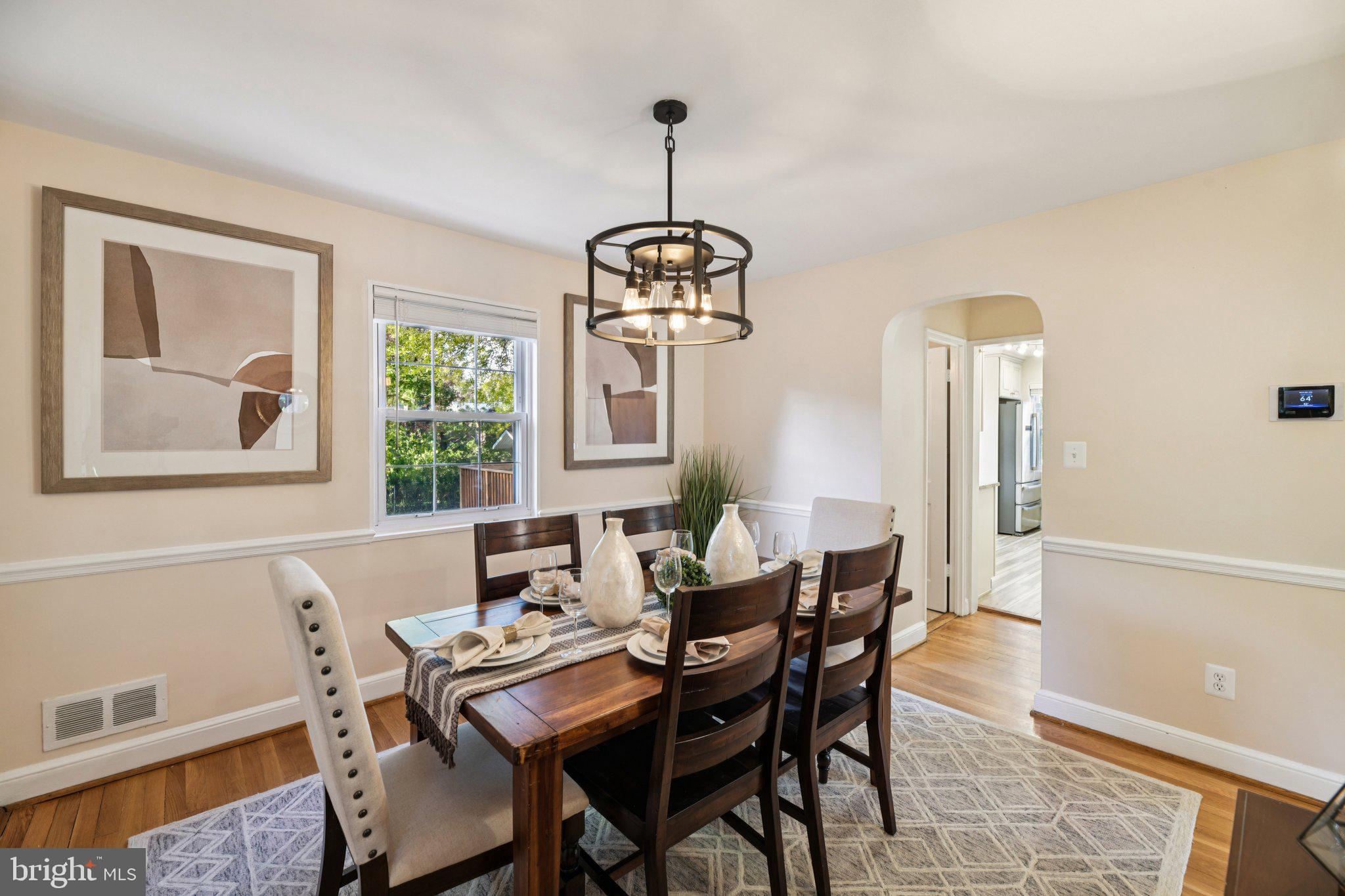 4012 Beechwood Road University Park, MD 20782 - Photo 4 of 56 a dining room with furniture a chandelier and wooden floor