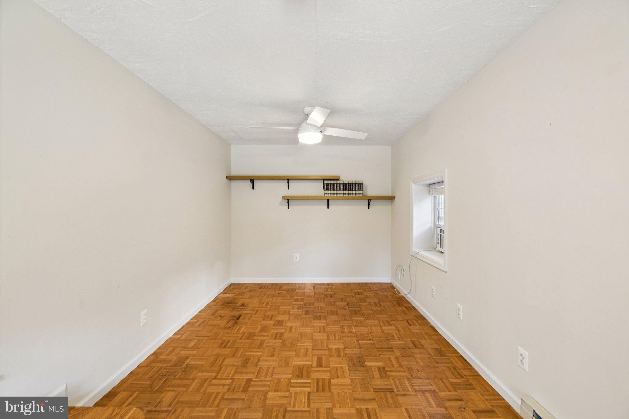 4012 Beechwood Road University Park, MD 20782 - Photo 43 of 56 an empty room with a ceiling fan and window