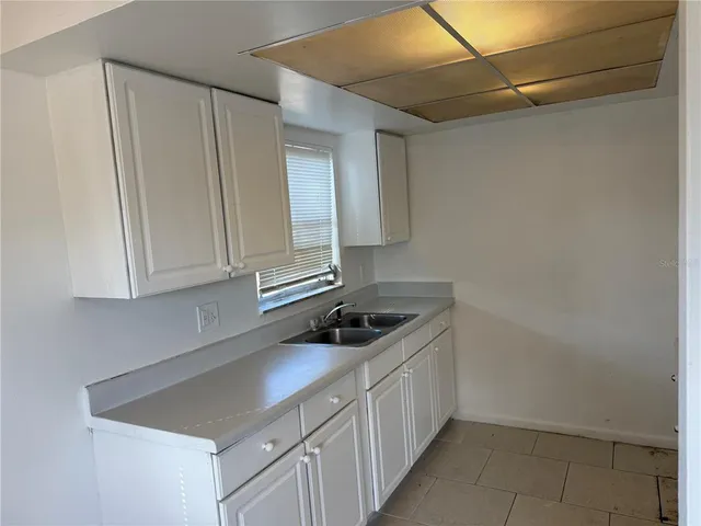 a kitchen with a sink and cabinets