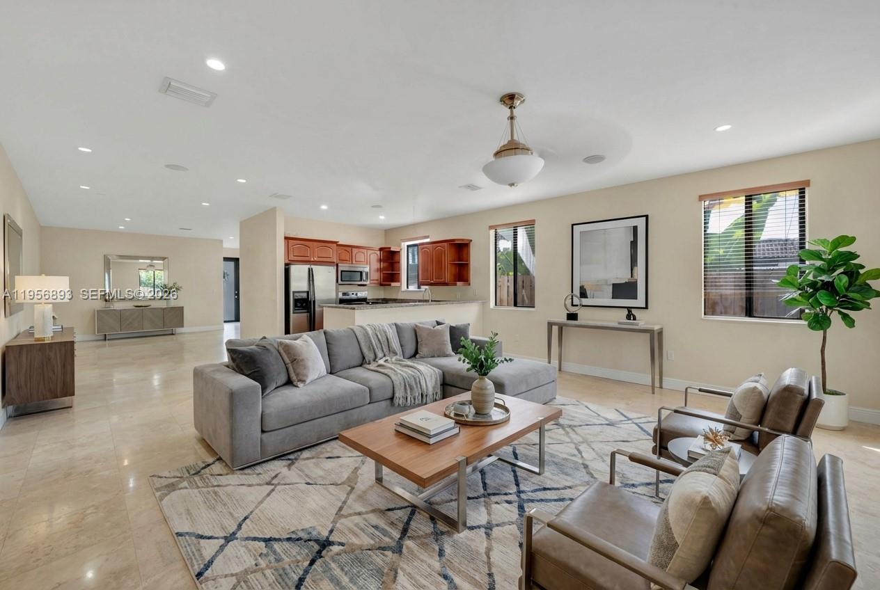 2654 Southwest 31st Place, Unit 2654 Miami, FL 33133 - Photo 2 of 17 a living room with furniture kitchen view and a table
