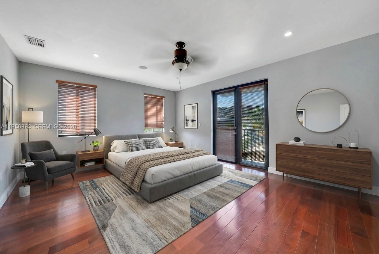 2654 Southwest 31st Place, Unit 2654 Miami, FL 33133 - Photo 7 of 17 a spacious bedroom with a bed a dresser and wooden floor