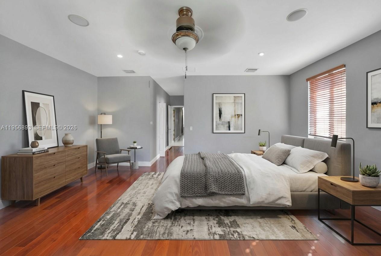 2654 Southwest 31st Place, Unit 2654 Miami, FL 33133 - Photo 8 of 17 a bedroom with a bed and wooden floor