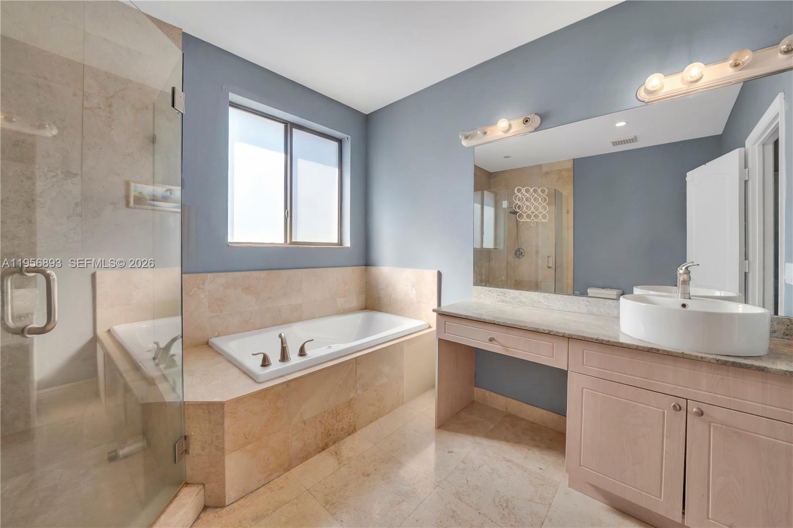 2654 Southwest 31st Place, Unit 2654 Miami, FL 33133 - Photo 10 of 17 a bathroom with a large tub sink and vanity