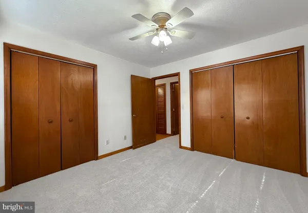 a view of a room with a ceiling fan