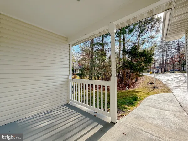 a view of a porch with wooden floor