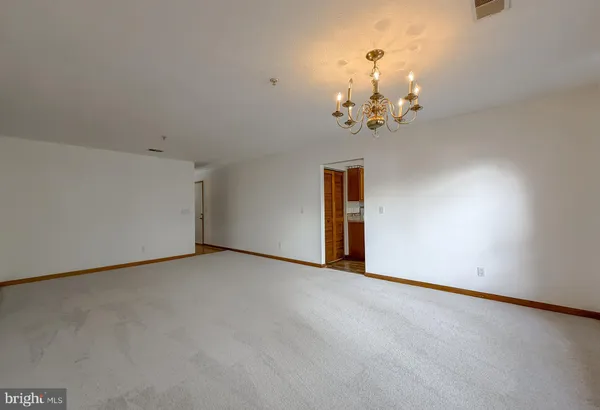 a view of an empty room with a chandelier