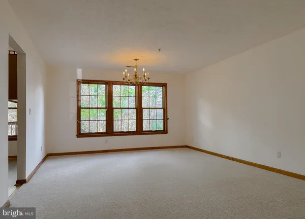 an empty room with a empty space and windows