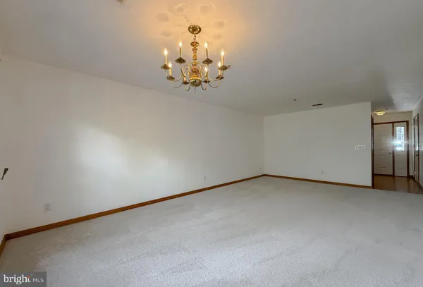 a view of a chandelier fan and fire place