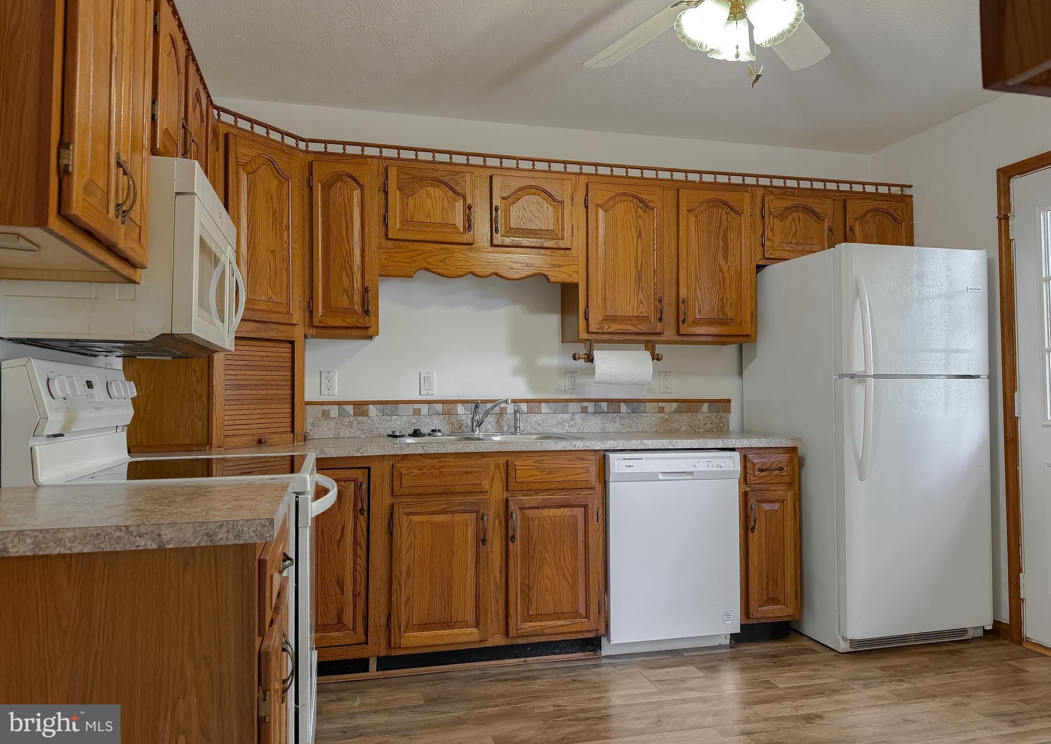 44029 Fieldstone Way California, MD 20619 - Photo 18 of 37 a kitchen with stainless steel appliances granite countertop a refrigerator a stove and a sink