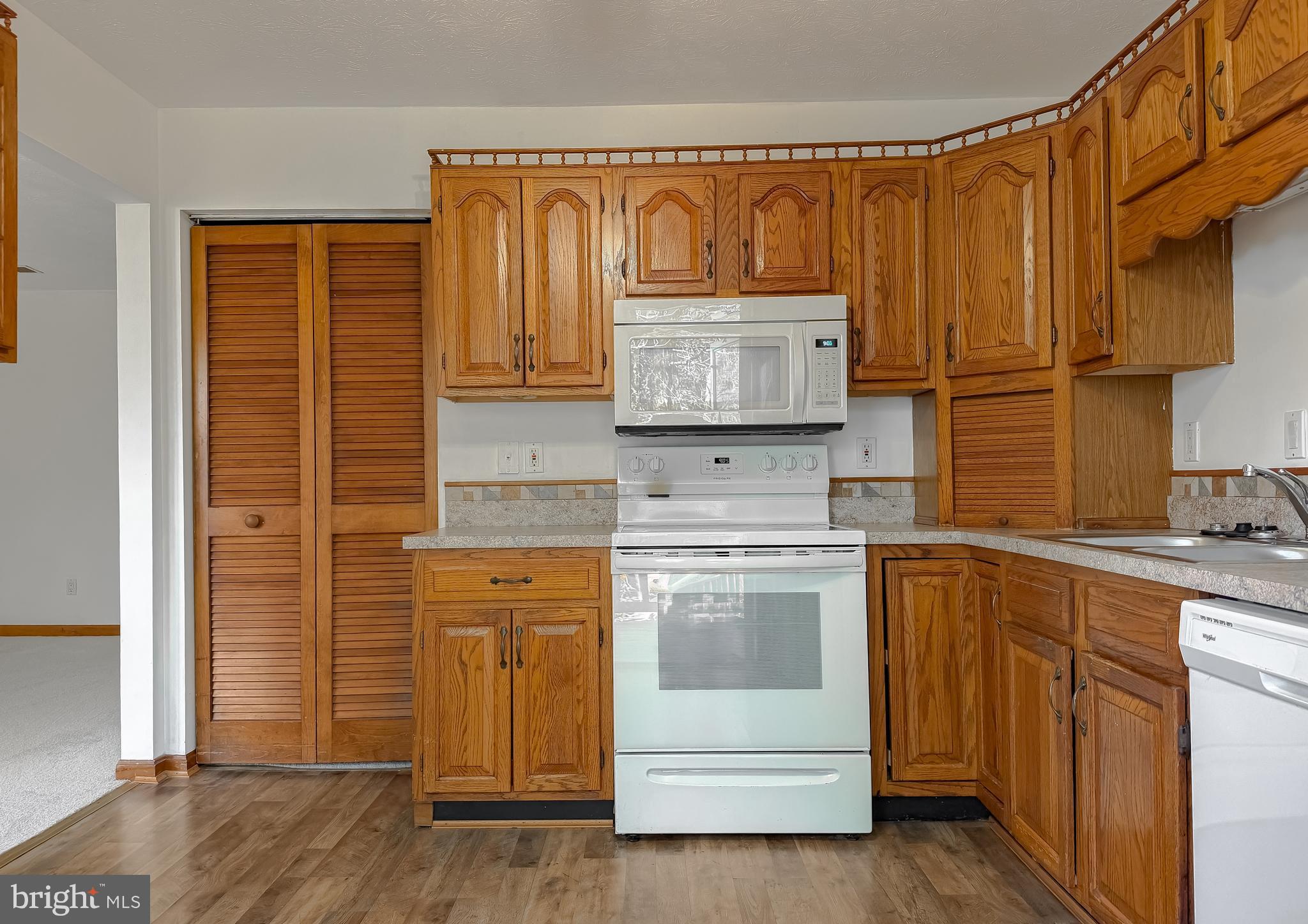 44029 Fieldstone Way California, MD 20619 - Photo 19 of 37 a kitchen with stainless steel appliances granite countertop a refrigerator and a stove top oven