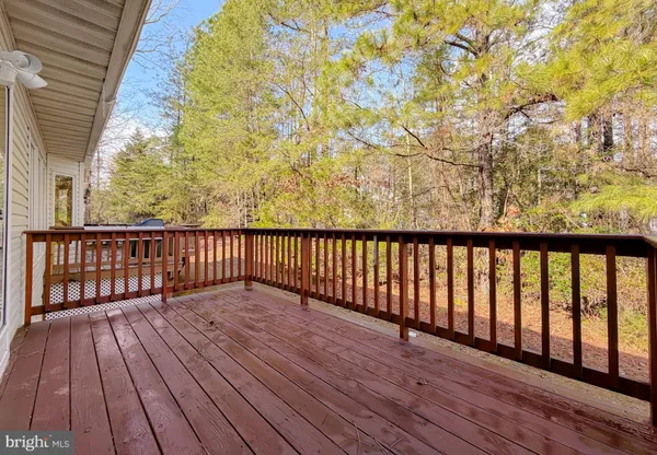 a view of wooden balcony with a bench