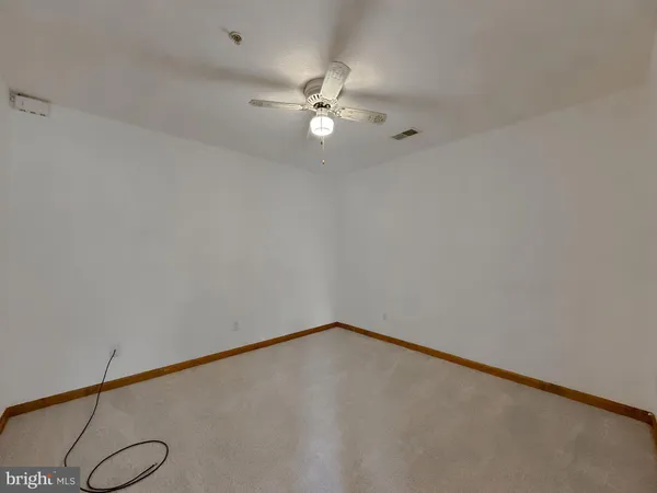 a view of a room with ceiling fan