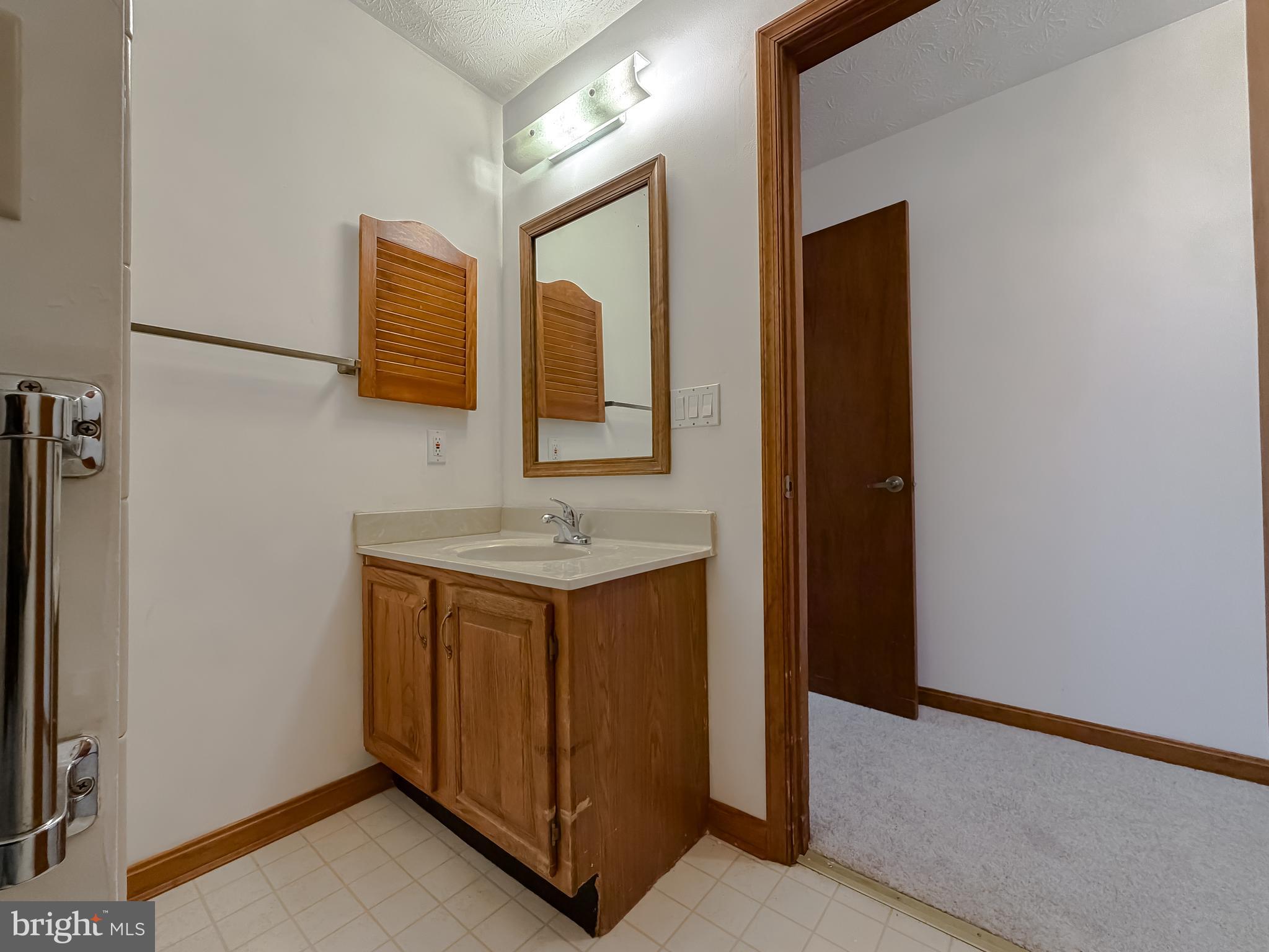 44029 Fieldstone Way California, MD 20619 - Photo 31 of 37 a bathroom with a sink and a mirror