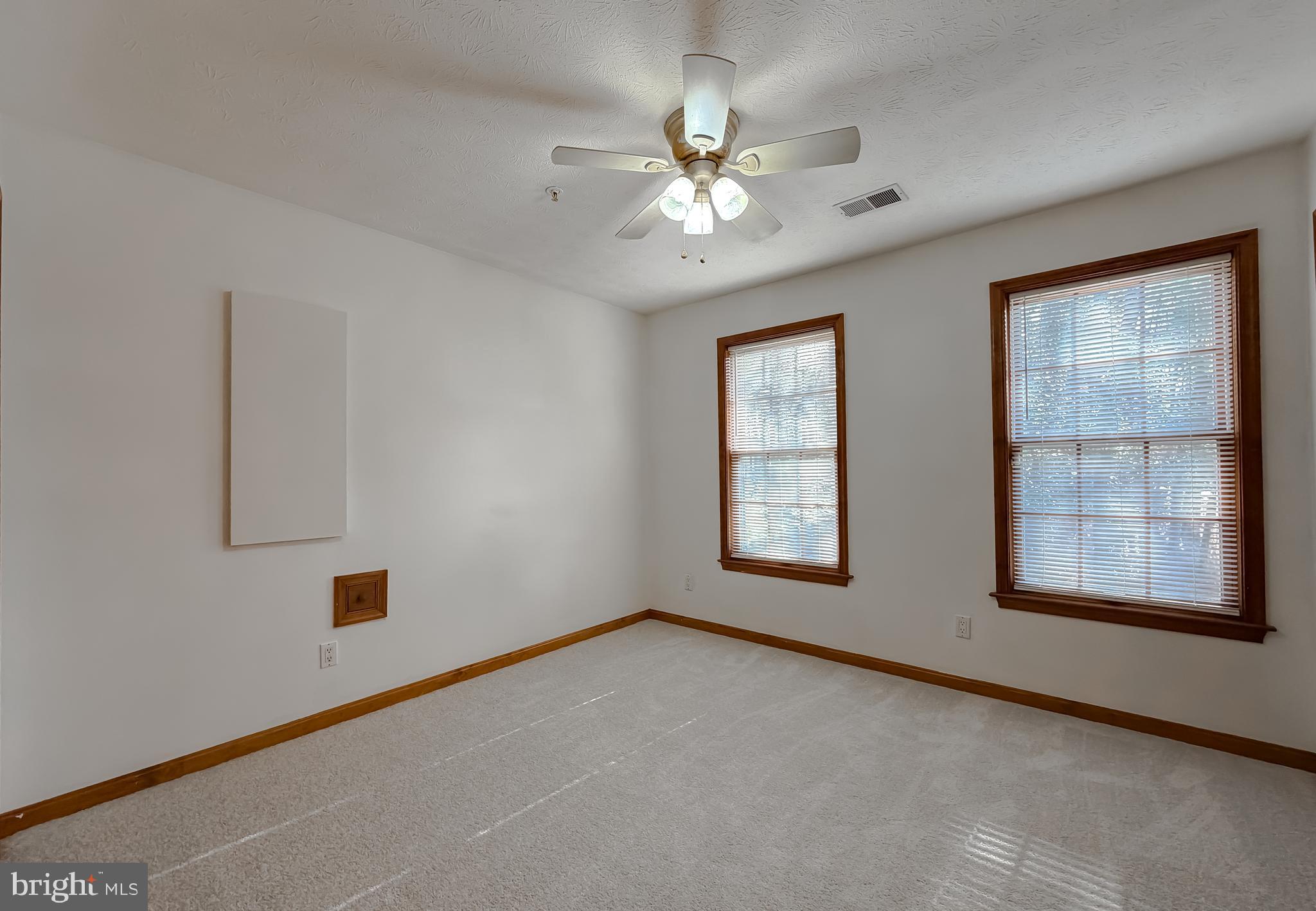 44029 Fieldstone Way California, MD 20619 - Photo 32 of 37 an empty room with chandelier fan and windows