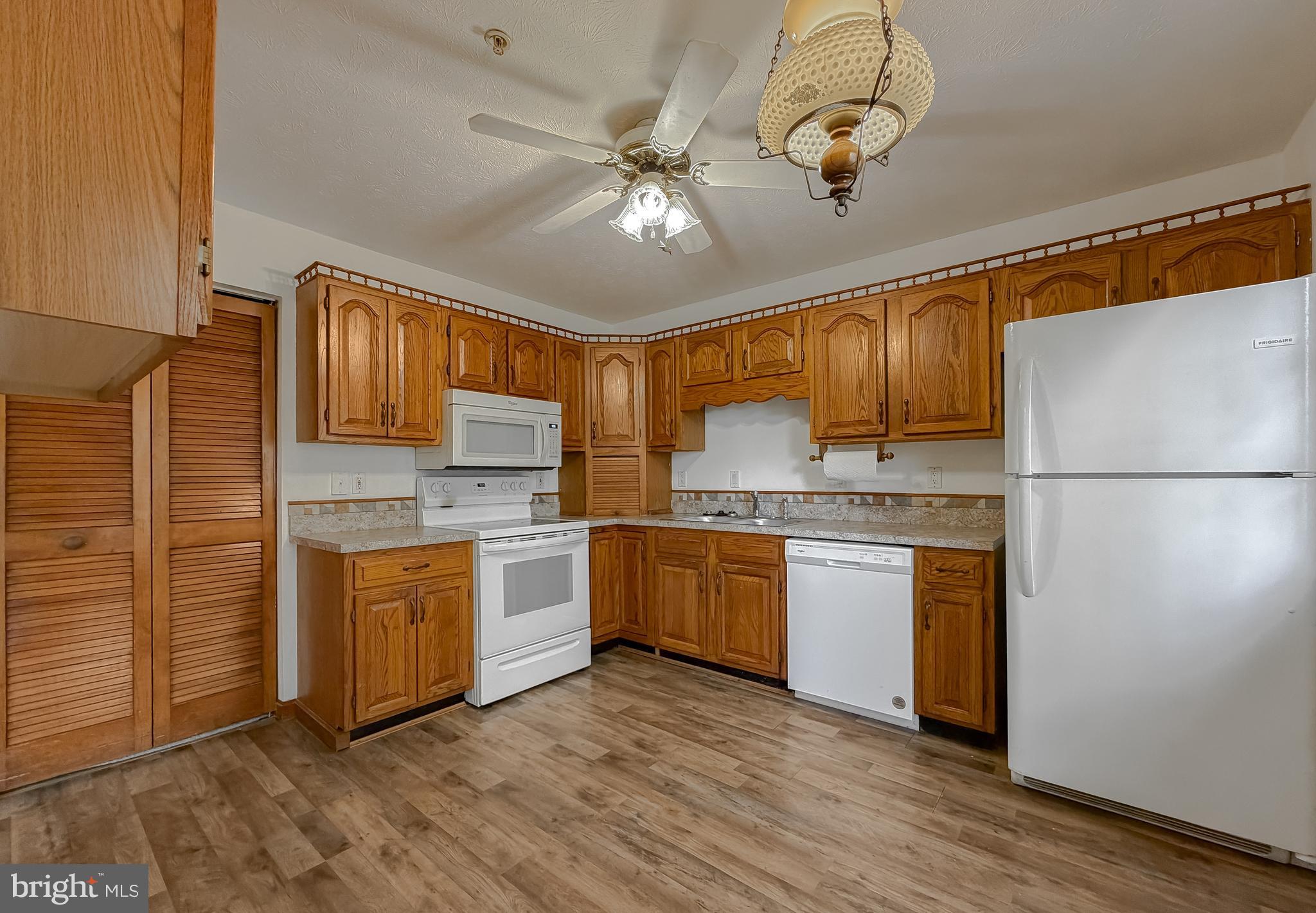 44029 Fieldstone Way California, MD 20619 - Photo 6 of 37 a kitchen with a refrigerator a stove top oven a sink and dishwasher