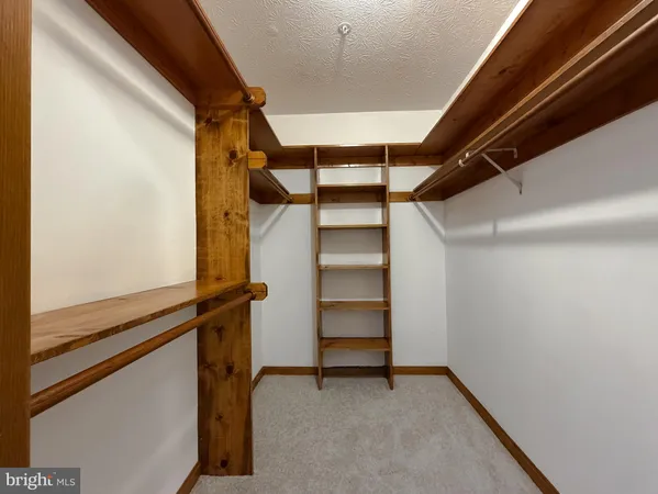 a view of an empty room with a staircase