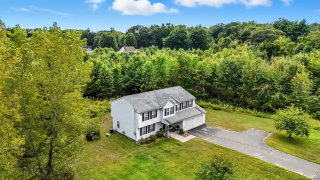 a backyard of a house with yard and outdoor seating