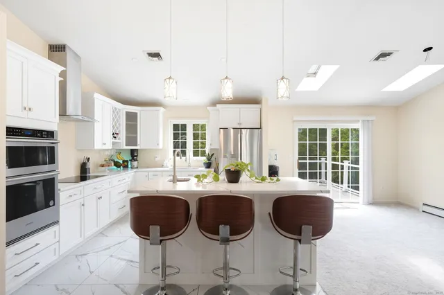 a kitchen with stainless steel appliances a refrigerator sink and cabinets