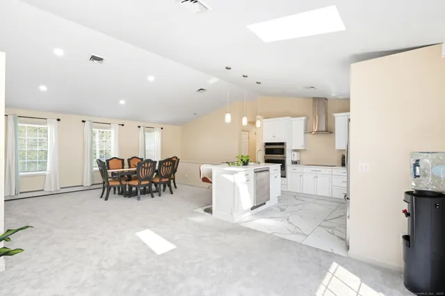 a view of a kitchen with a sink and refrigerator