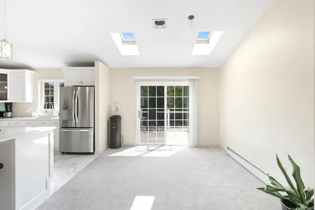 a view of a dining room with furniture and a window