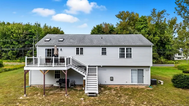 a aerial view of a house with yard and lake view