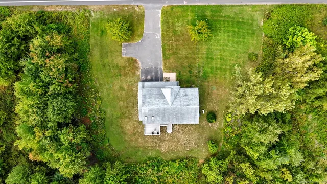 an aerial view of a residential houses with outdoor space
