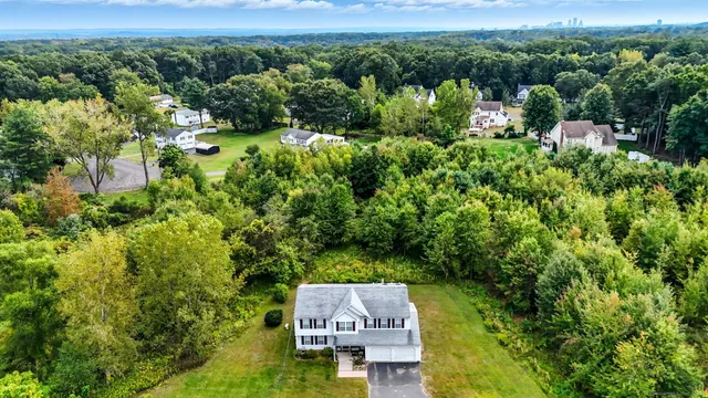 an aerial view of a house with a yard