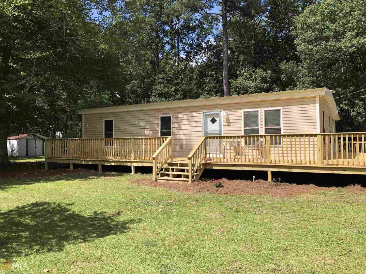 353 Crane Road Zebulon, GA 30295 - Photo 1 of 1 a backyard of a house with table and chairs