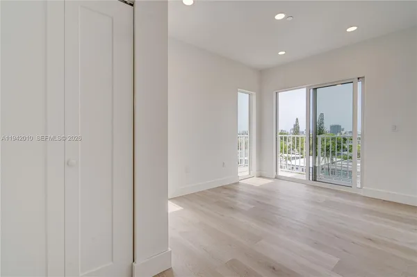 a view of a livingroom with wooden floor and entryway