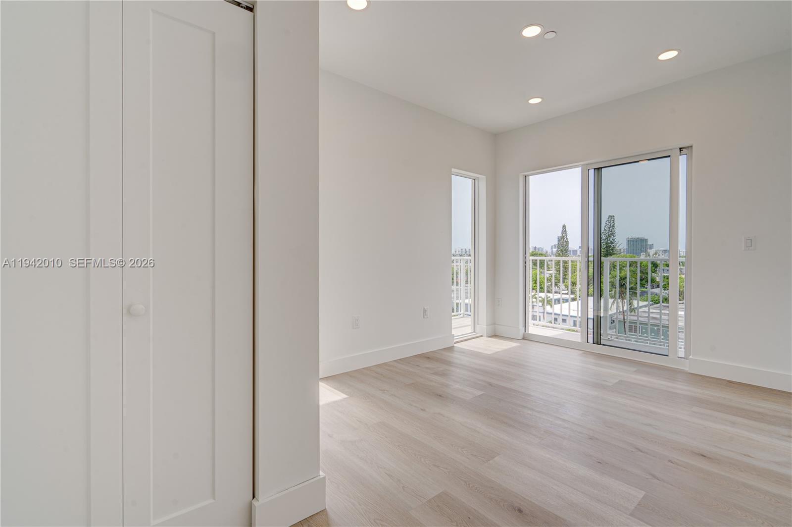 816 84th Street, Unit 2 Miami Beach, FL 33141 - Photo 11 of 19 a view of a livingroom with wooden floor and entryway