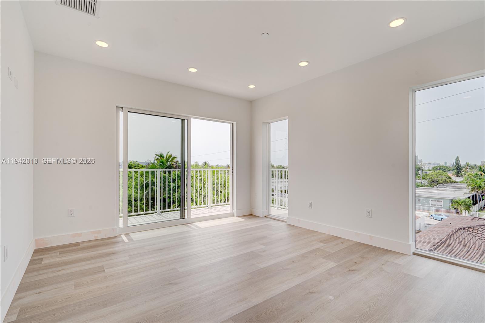 816 84th Street, Unit 2 Miami Beach, FL 33141 - Photo 17 of 19 a view of an empty room with a sliding door