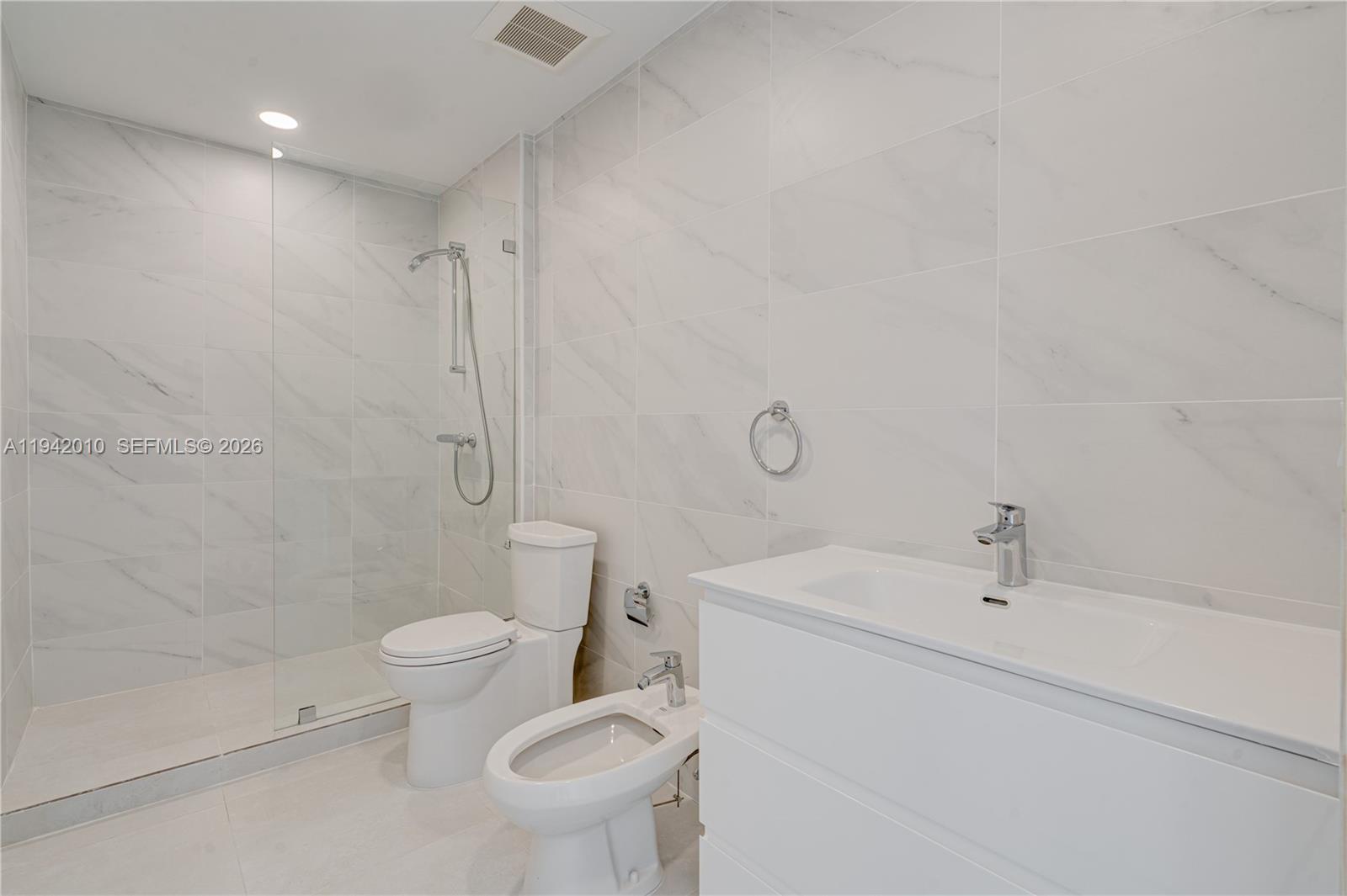 816 84th Street, Unit 2 Miami Beach, FL 33141 - Photo 9 of 19 a bathroom with a sink toilet and shower