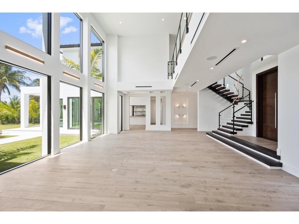19311 North Riverside Drive Tequesta, FL 33469 - Photo 13 of 31 a view of an entryway with floor to windows and living room