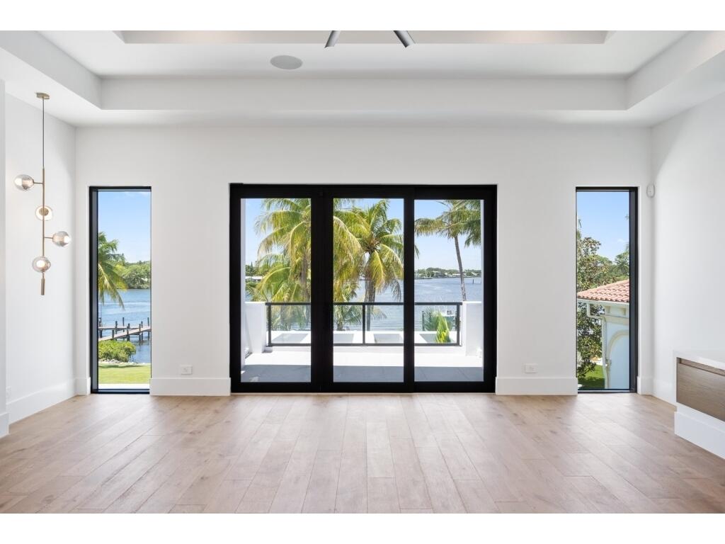 19311 North Riverside Drive Tequesta, FL 33469 - Photo 23 of 31 a view of an empty room with wooden floor and a window