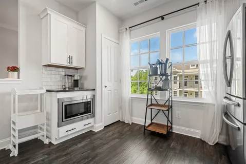 a kitchen with stainless steel appliances a stove a sink and a refrigerator
