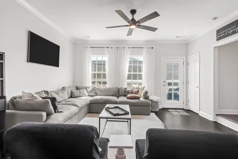 a living room with furniture and a flat screen tv