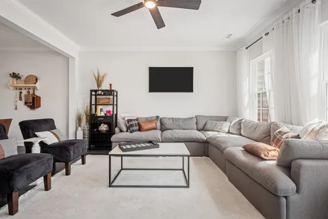 a living room with furniture and a flat screen tv
