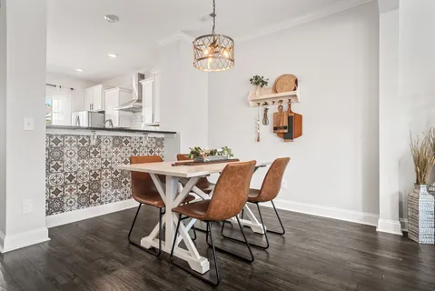 a view of a dining room with furniture and wooden floor