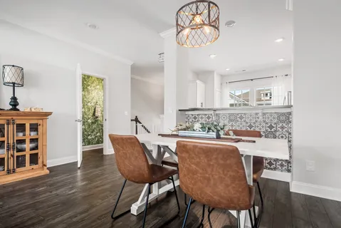 a view of a dining room with furniture wooden floor and chandelier
