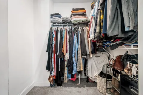 a view of walk in closet with clothes