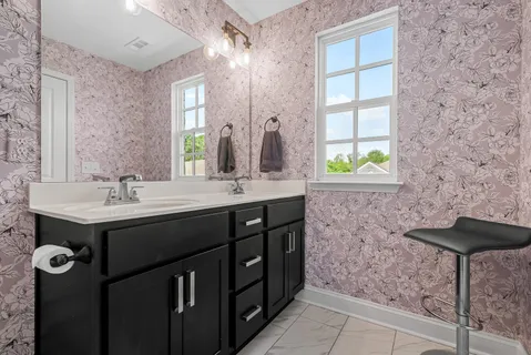 a bathroom with a double vanity sink a and a mirror