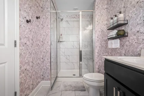 a bathroom with a toilet and shower